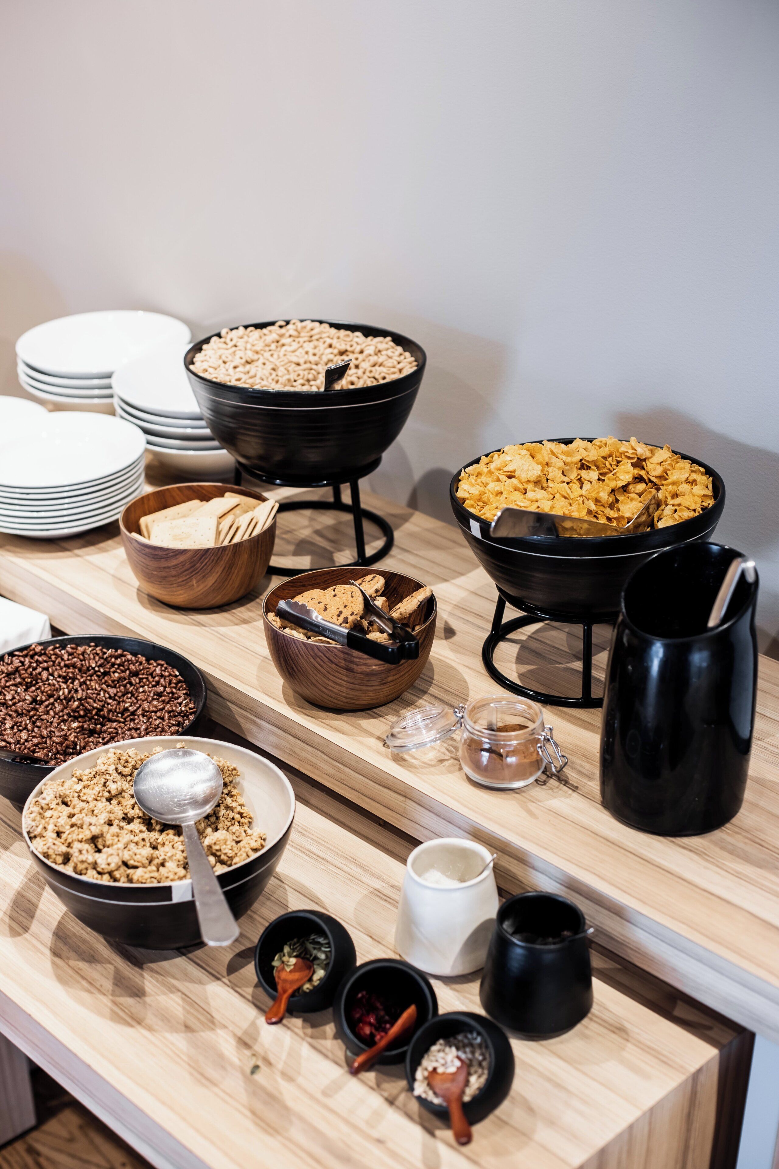 A buffet table with various food items and serving utensils.