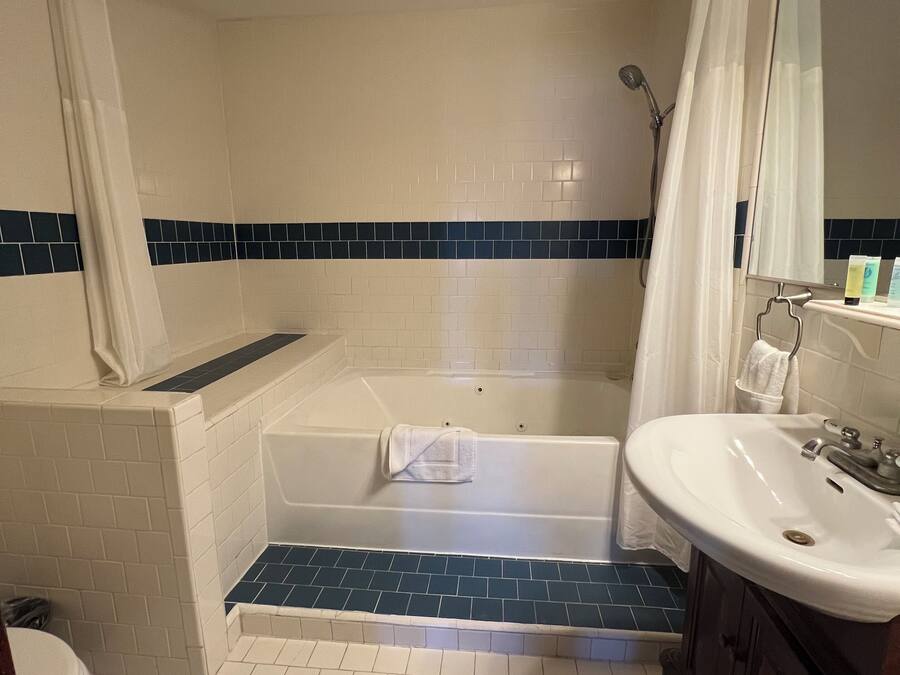 A bathroom with a bathtub, a sink, and a shower.