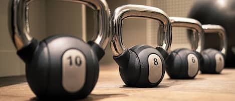 A row of kettlebells with weights labeled 6, 8, and 10.