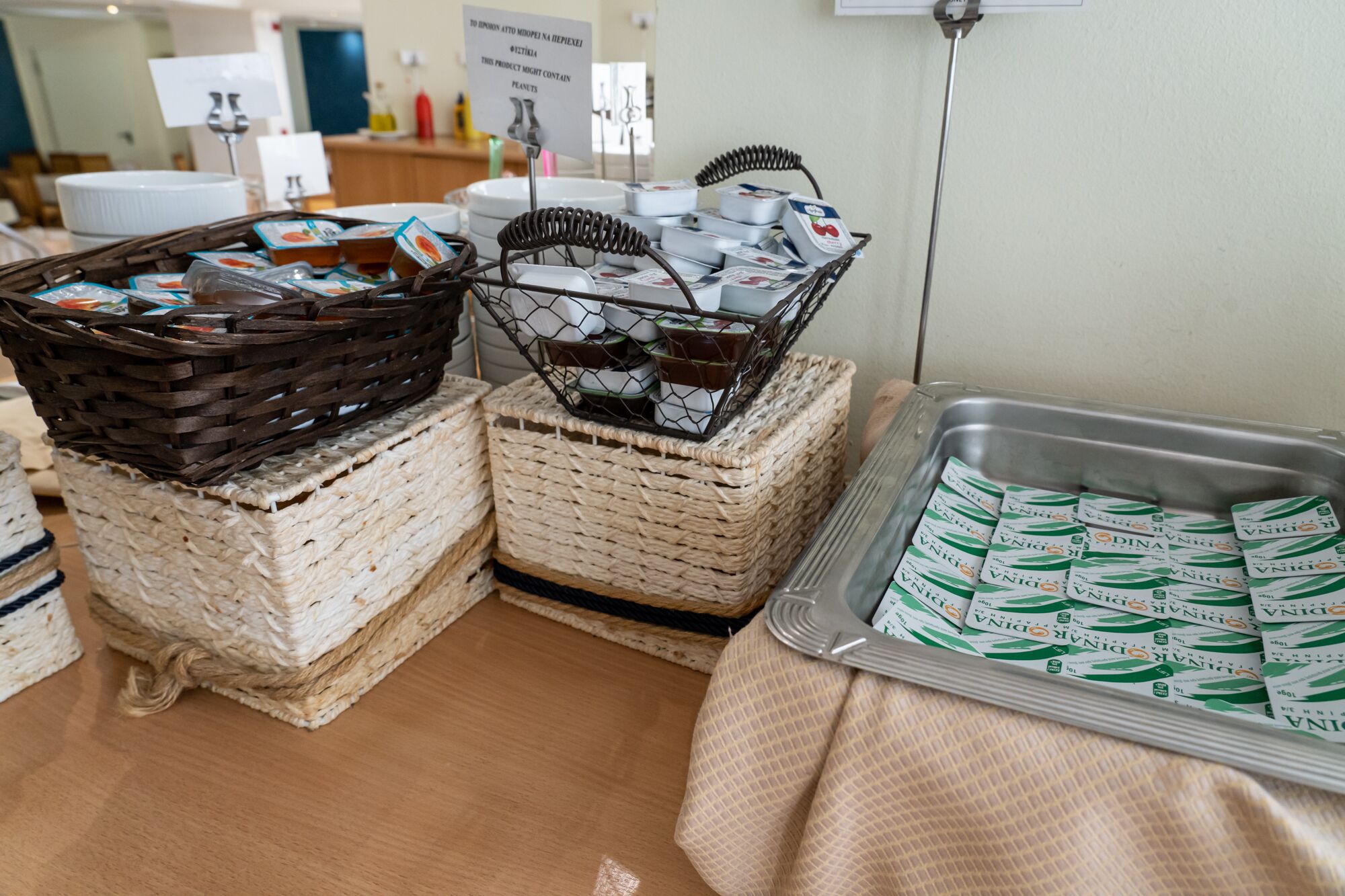 A buffet setup with various food items in baskets and trays.