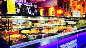 A buffet with various food items displayed in a glass case. - Hotel Blue Rose's (Mesagne)