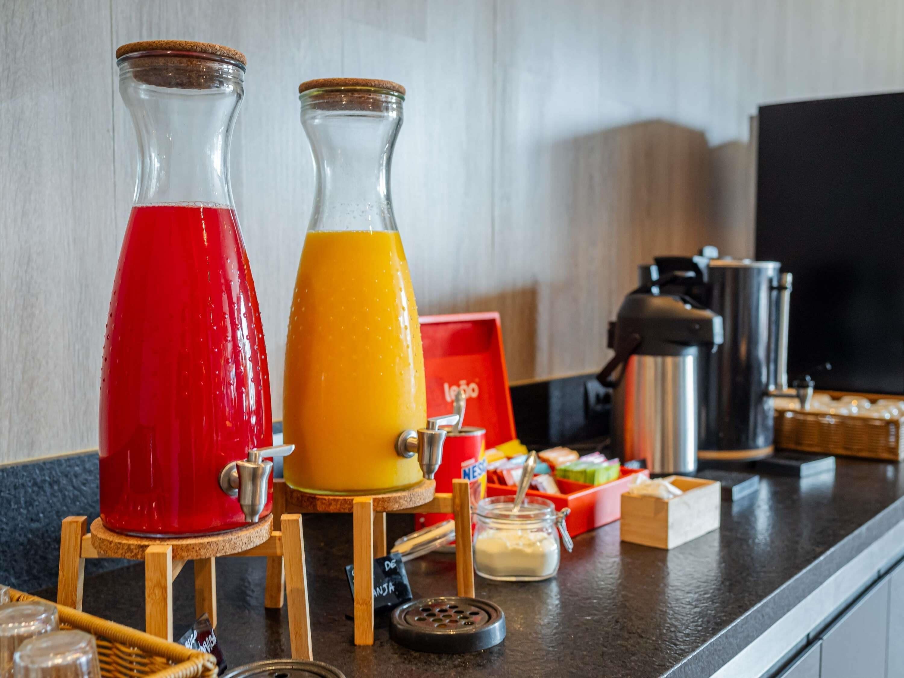 Two glass carafes on wooden stands, a coffee machine, and a red box labeled 'Nespresso' on a kitchen counter.