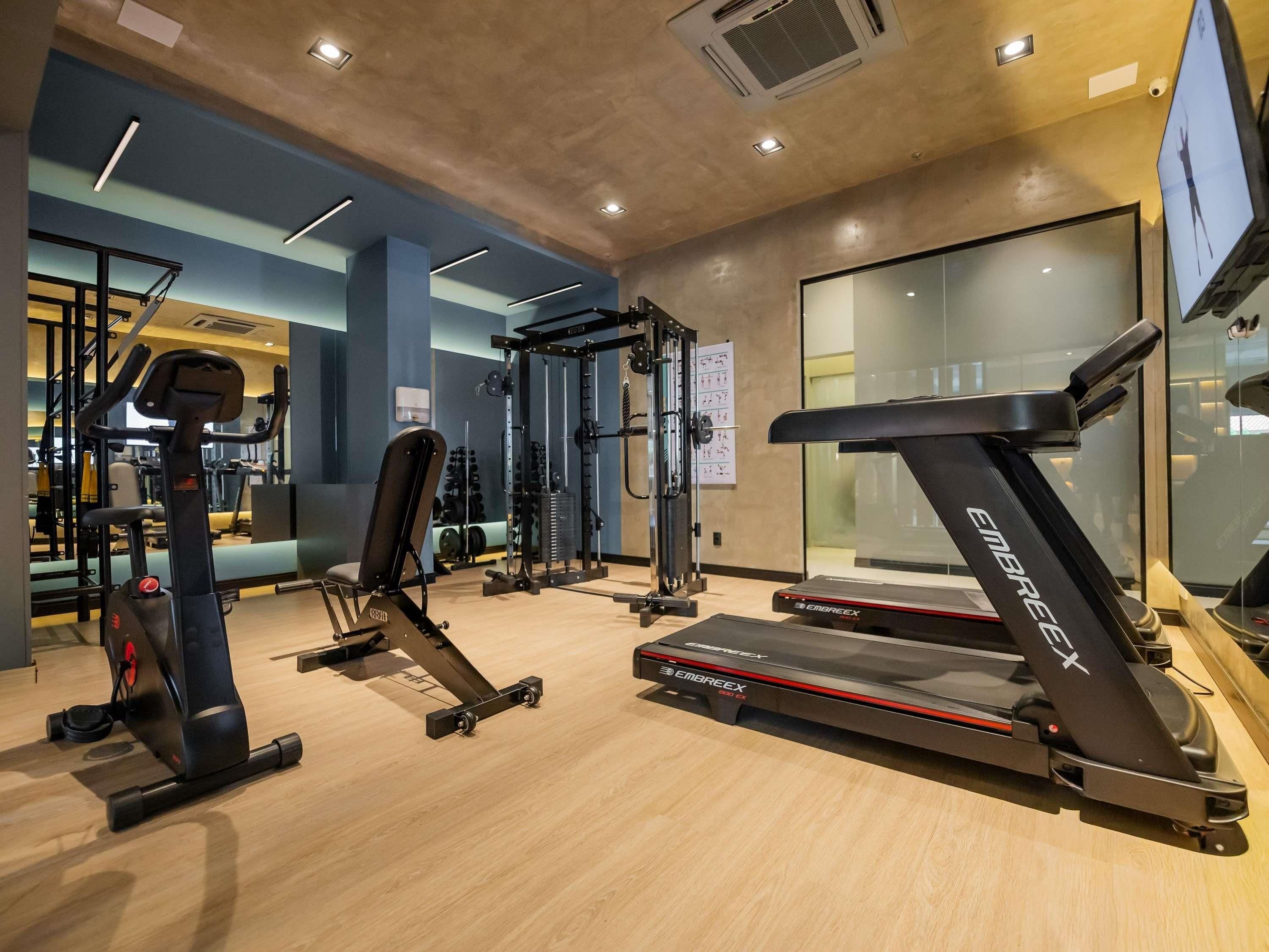 A gym with treadmills, weight machines, and free weights.