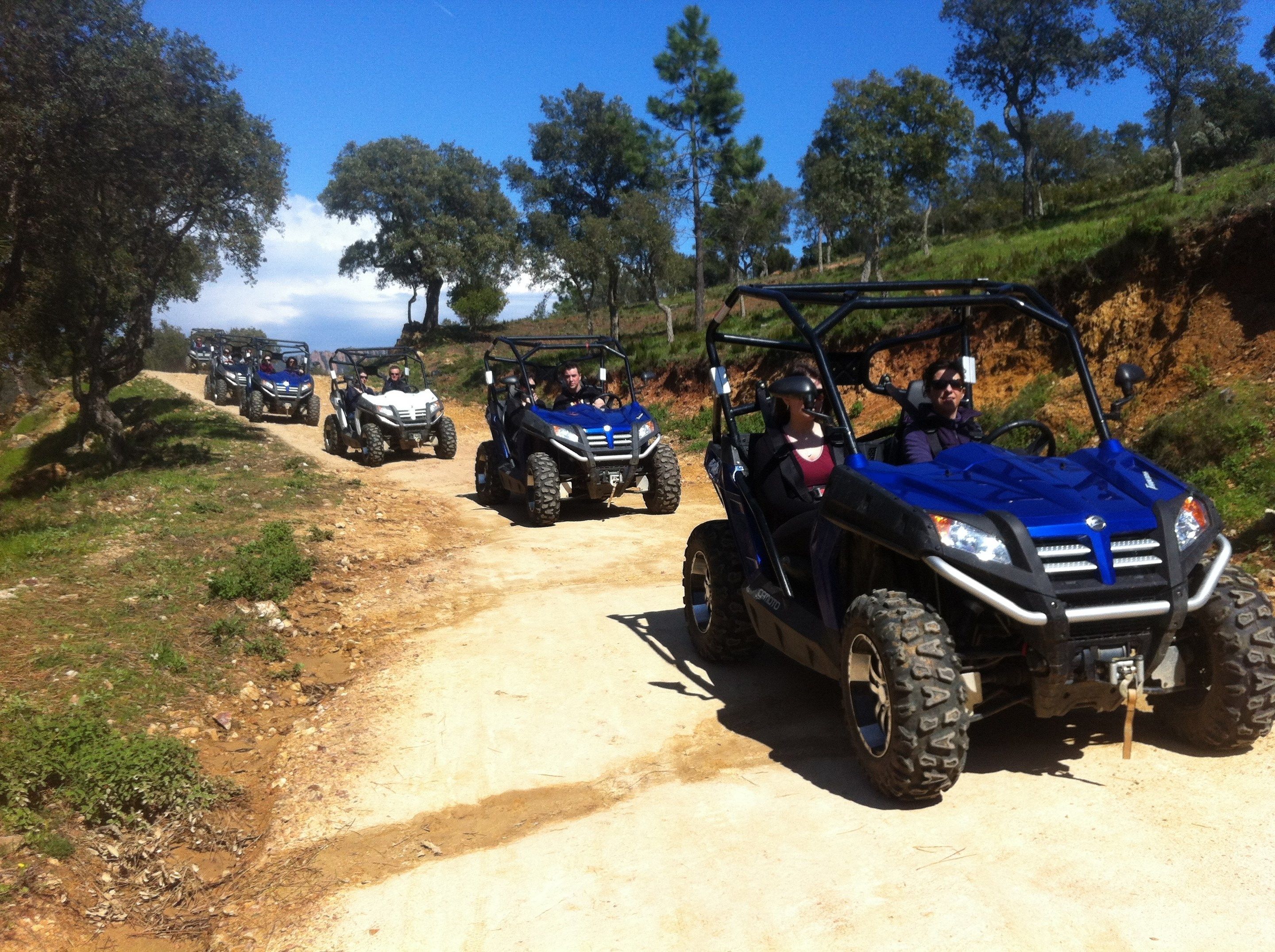 A dirt path with off-road vehicles.