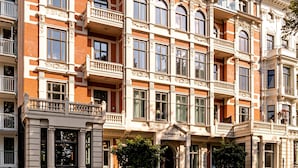 A multi-story building with a classic architectural style, featuring ornate balconies and large windows.