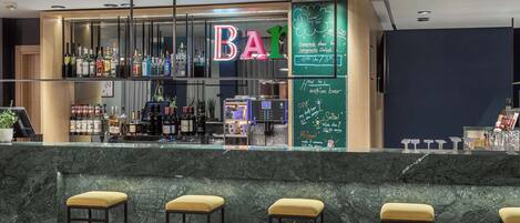 A bar area with a neon sign, a variety of liquor bottles, and a chalkboard menu.
