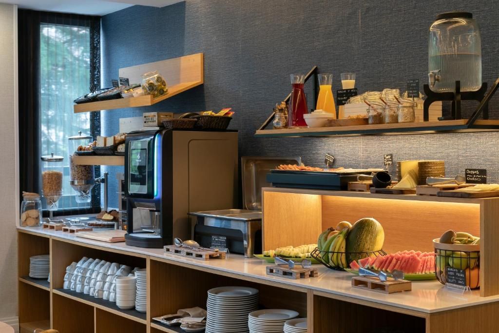 A breakfast buffet with various food items and a coffee machine.