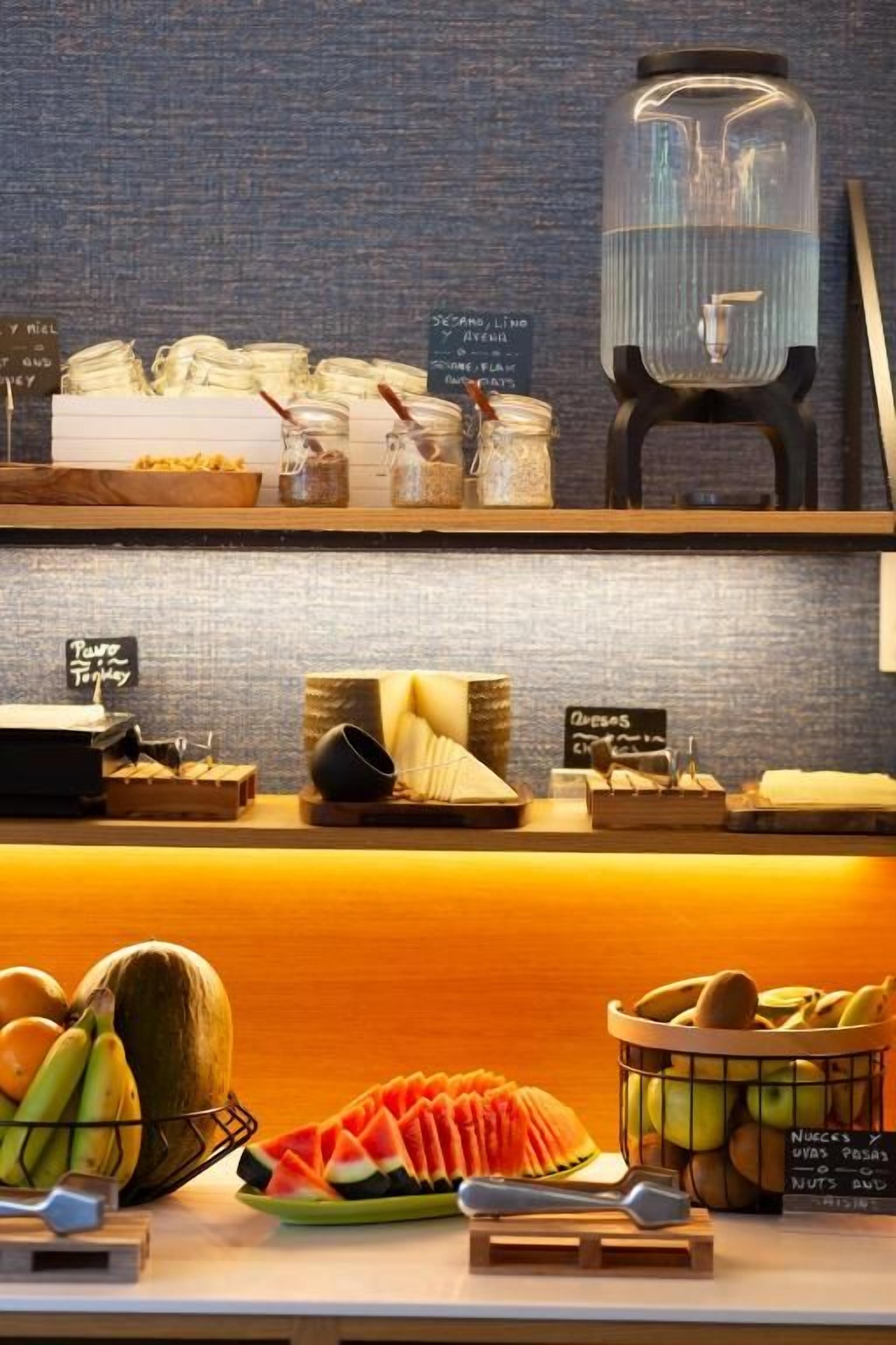A breakfast buffet with various food items and a coffee station.