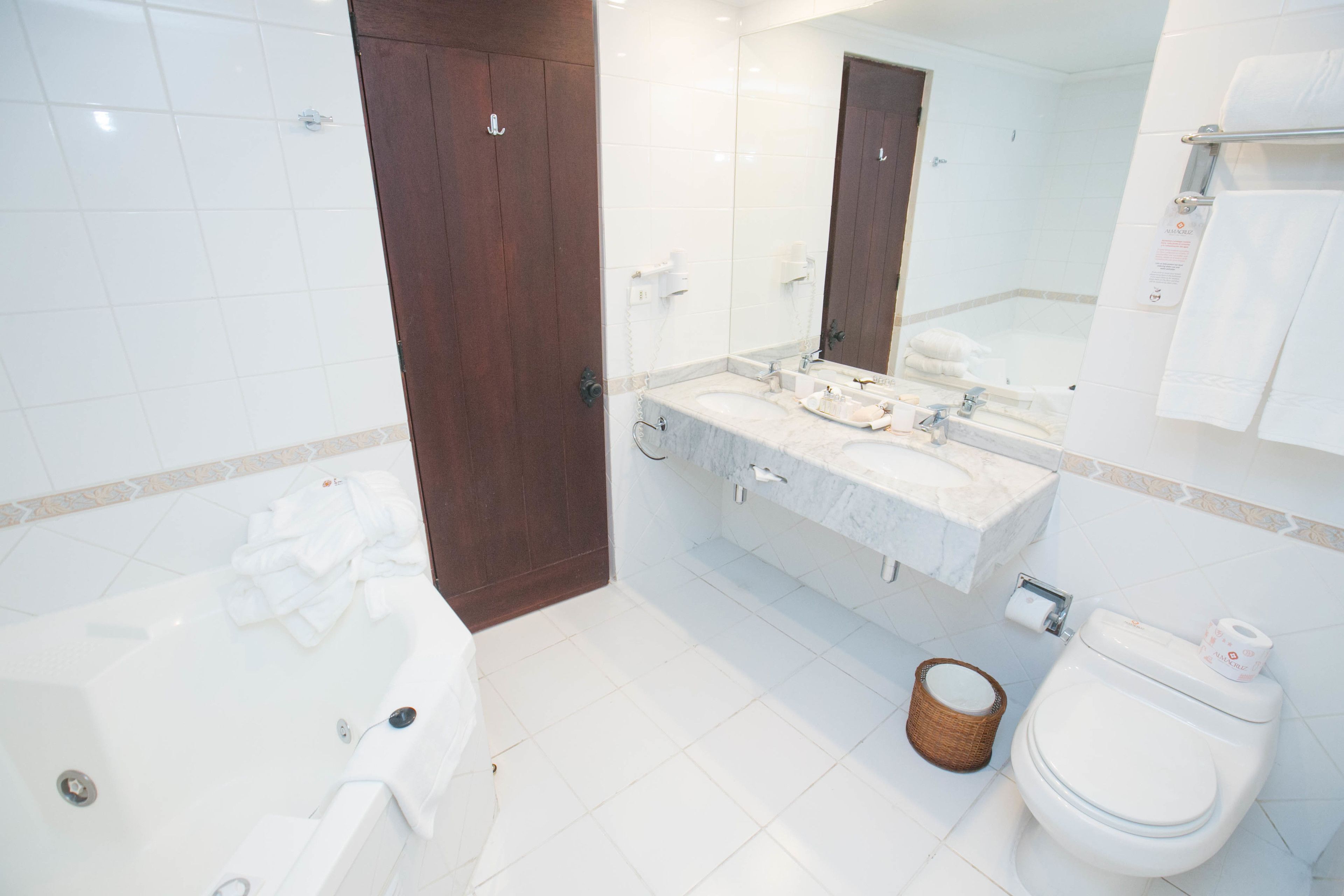 combined shower/bathtub, designer toiletries, hair dryer, towels