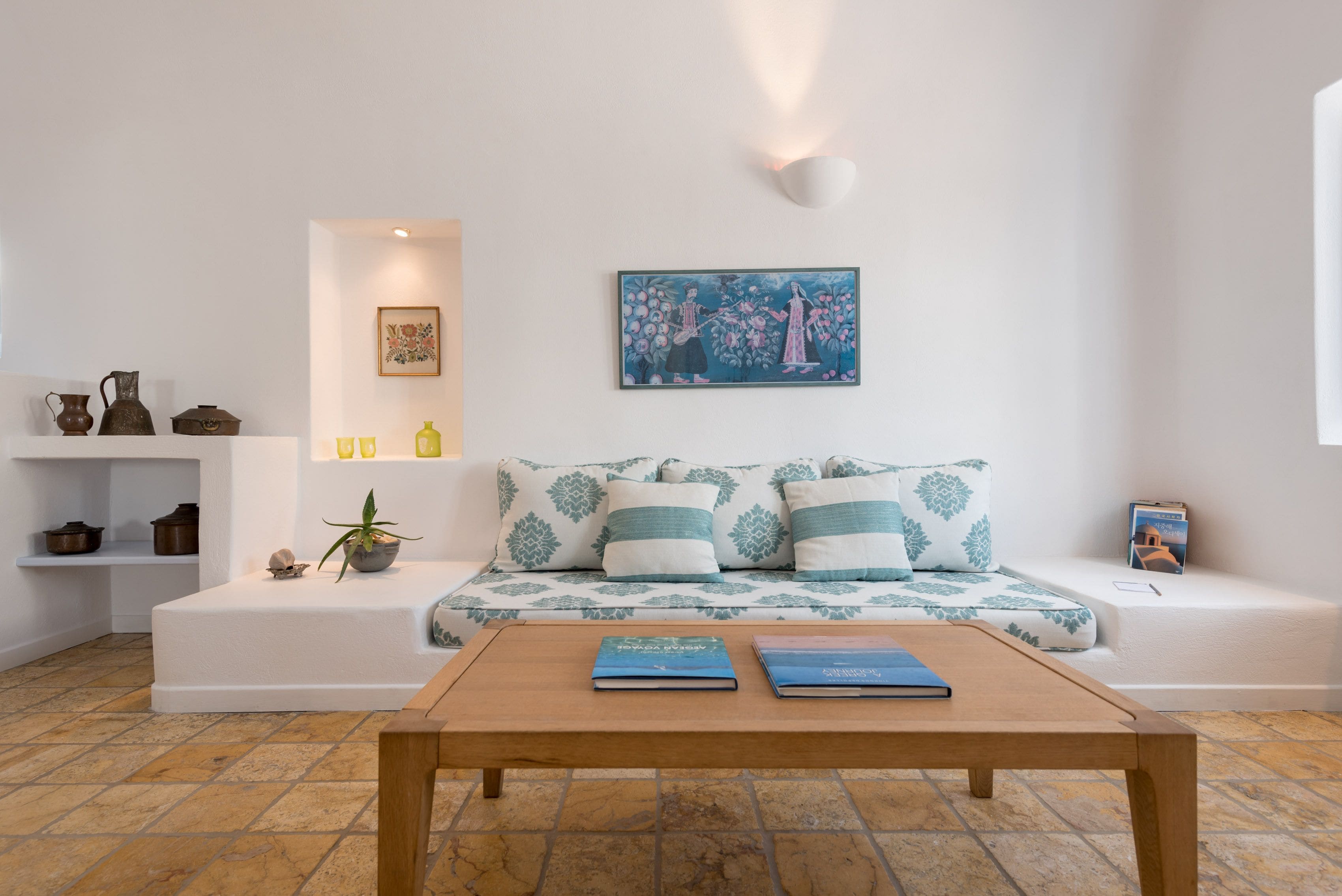 A modern living room with a sofa, a coffee table, and a bookshelf.