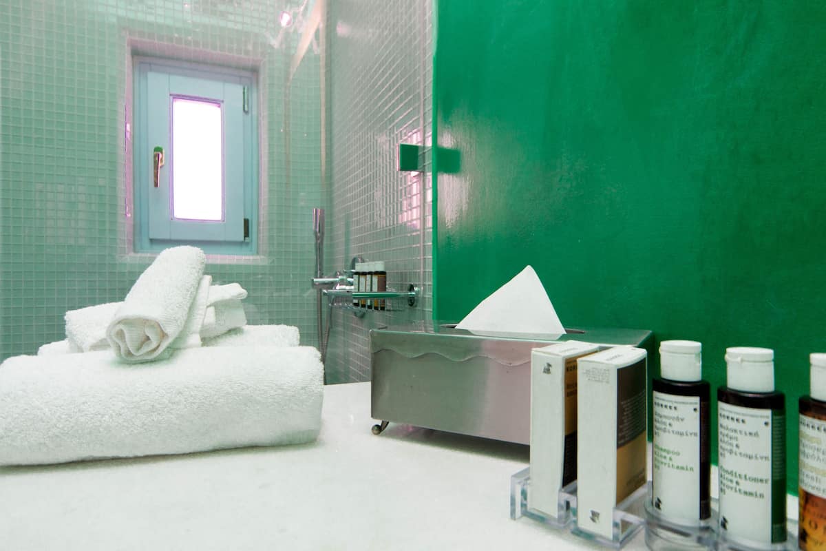 suite (aida) caldera view | bathroom | shower, designer toiletries, hair dryer, bathrobes