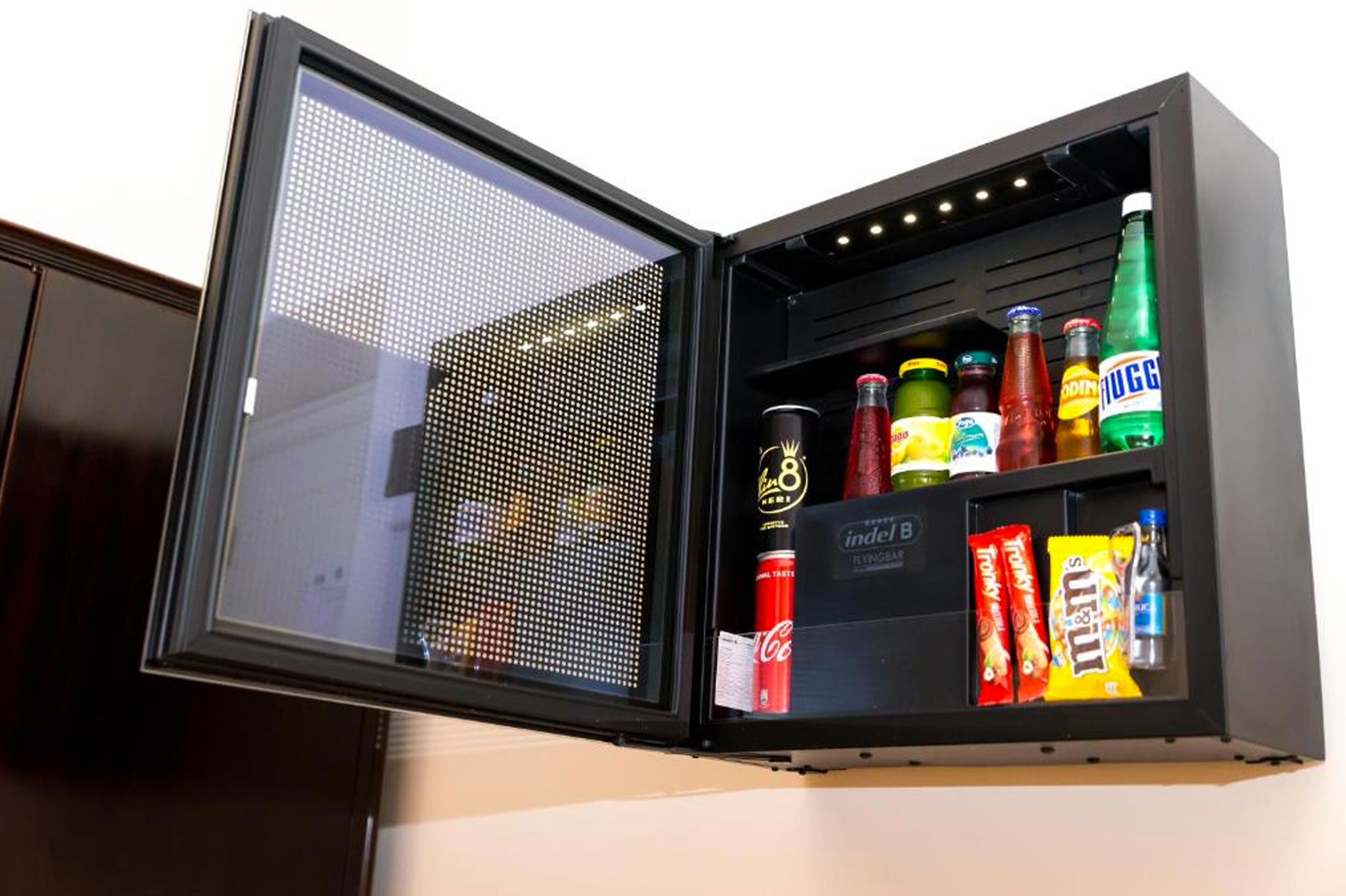 A minibar with various beverages and snacks.
