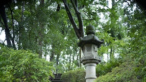 A stone staircase surrounded by lush greenery, leading up to a traditional pagoda. - Hyatt Regency Kyoto (Kyoto)