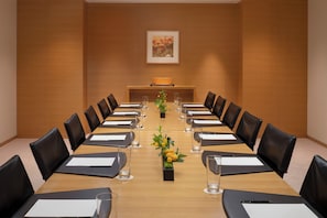 A conference room with a long table, black leather chairs, and a small plant centerpiece. - Hyatt Regency Kyoto (Kyoto)