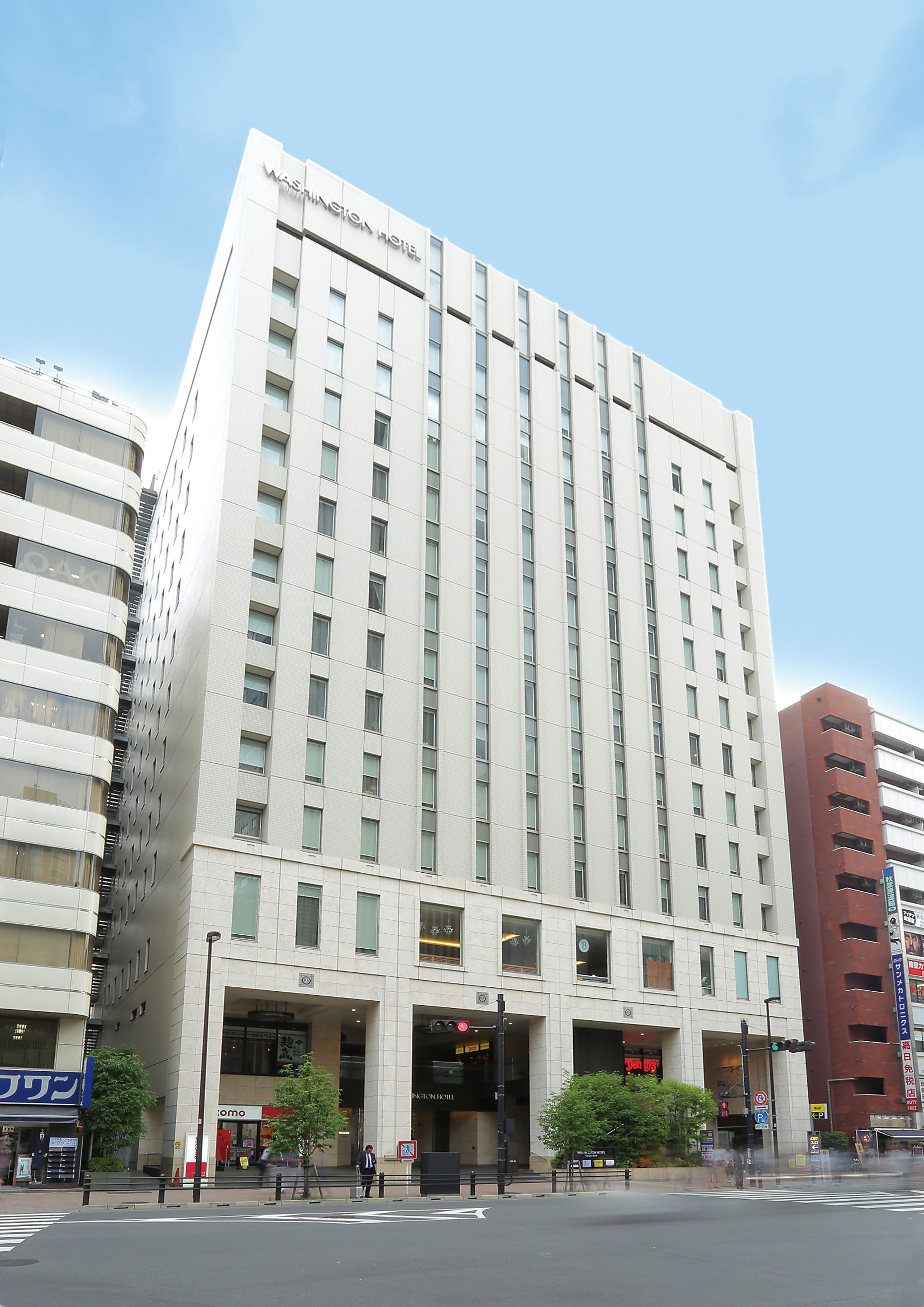 A tall hotel with a modern design, featuring a prominent entrance and multiple floors.