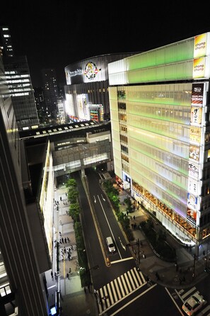 A modern urban street scene with high-rise buildings, a pedestrian crossing, and a busy intersection. - Akihabara Washington Hotel (Tokyo)