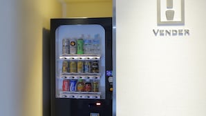 A vending machine with various beverages and snacks, including cans and bottles, with a digital display and price tags. - Akihabara Washington Hotel (Tokyo)