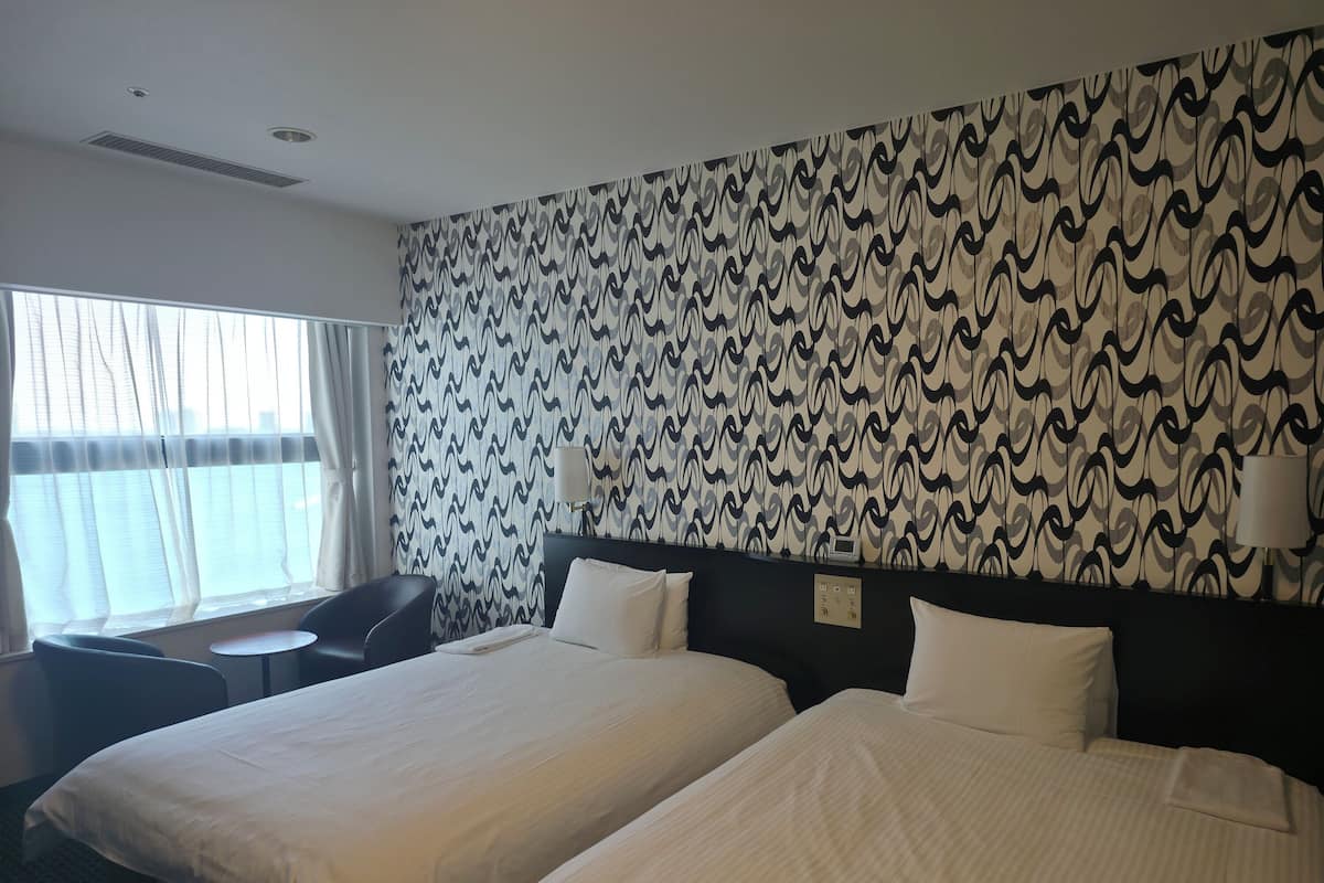 Premium bedding, desk, laptop workspace, blackout drapes