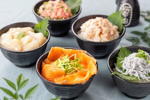 A variety of bowls containing different types of food, likely Japanese cuisine, arranged on a table. - Tokyo Bay Ariake Washington Hotel (Tokyo)