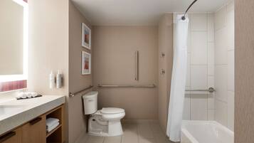 A modern bathroom with a toilet, sink, and bathtub.
