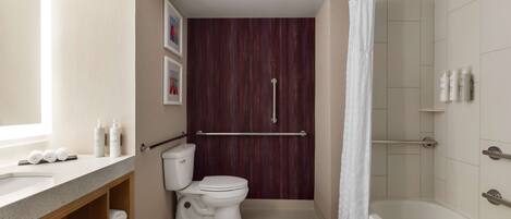 A modern bathroom with a toilet, sink, and shower.