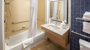 A bathroom with a bathtub, a shower, a sink, and a toilet.