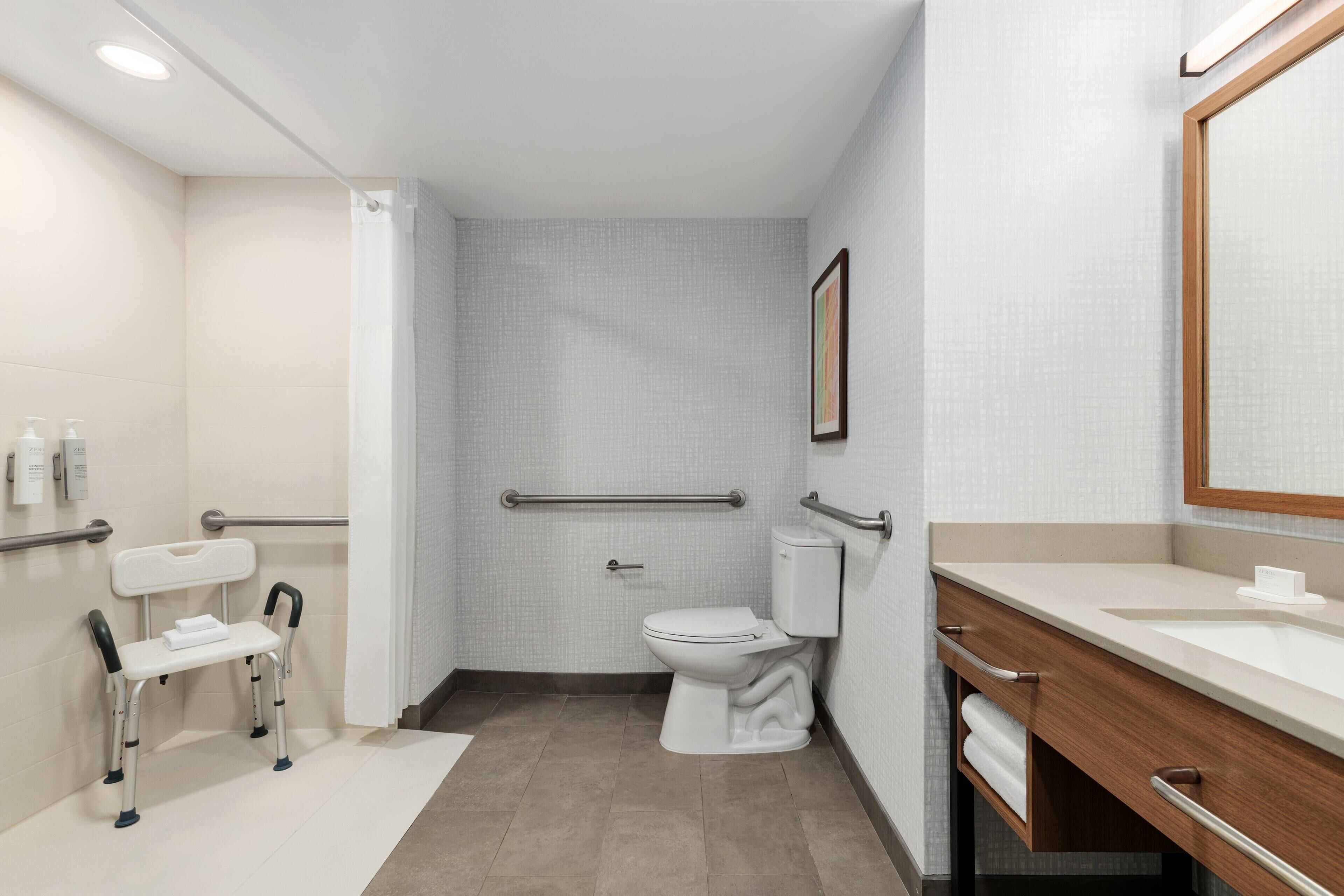 Room, 1 King Bed, Accessible (Roll-In Shower) | Bathroom | Combined shower/tub, deep soaking tub, free toiletries, hair dryer
