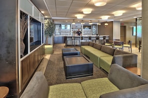 A bar area with seating and a bartender. - Holiday Inn & Suites Albuquerque-North I-25 by IHG (Albuquerque)