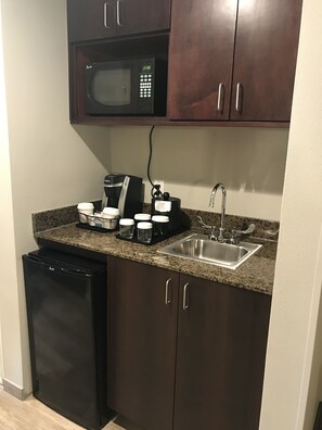 A compact kitchen with a microwave, coffee maker, and sink. - Holiday Inn & Suites Albuquerque-North I-25 by IHG (Albuquerque)