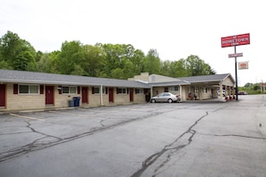 A motel with a parking lot, a sign for Hometown Inn, and a AAA Approved sign.
