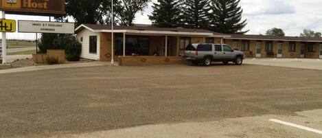 A Budget Host motel with a parking lot and a single-story building.