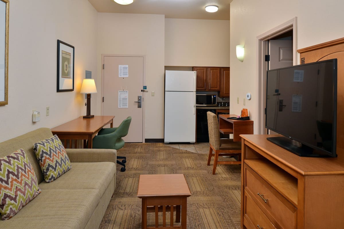 A compact living space with a kitchenette, a dining area, and a seating area.