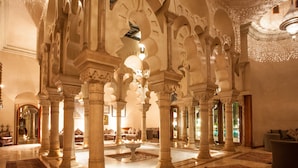 A spacious lobby with high, ornate arches and a central seating area. - Palais Mehdi (Marrakech)