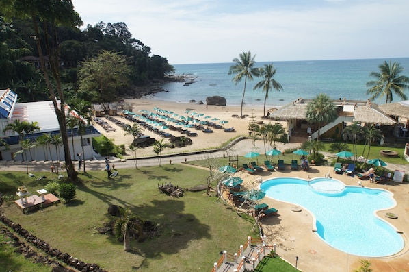 A resort with a swimming pool, beach, and thatched-roof structures. - Khaolak Sunset Resort - Adults Only (SHA Extra Plus) (Takua Pa)