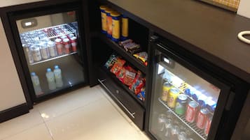 A compact minibar with beverages, snacks, and a small refrigerator.