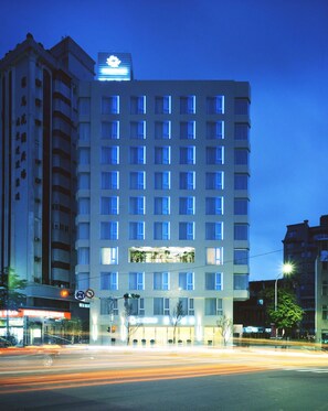 A multi-story hotel with a modern facade, featuring a prominent sign at the top. - Ambience Hotel Taipei (Taipei)