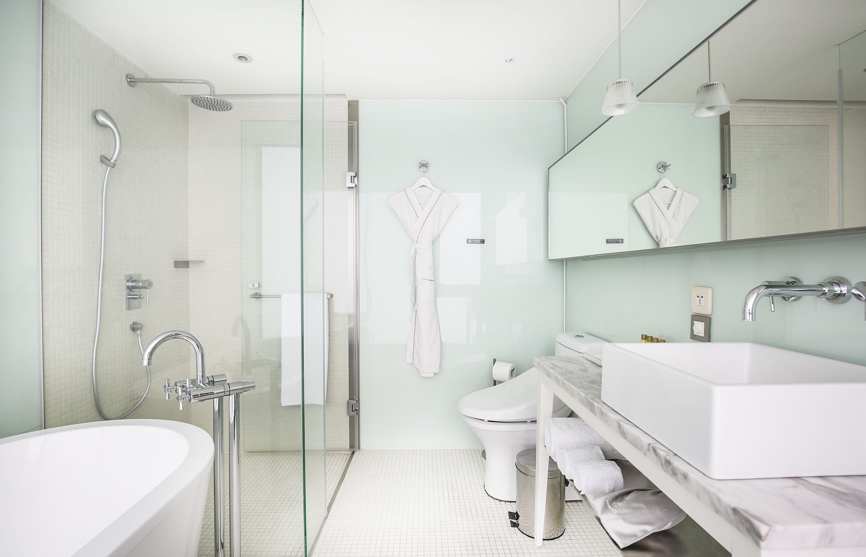 corner room, bathtub, city view | bathroom | hair dryer, slippers, towels, shampoo