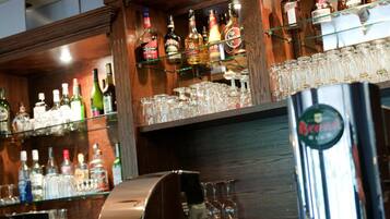 A bar area with shelves of liquor bottles and glasses.