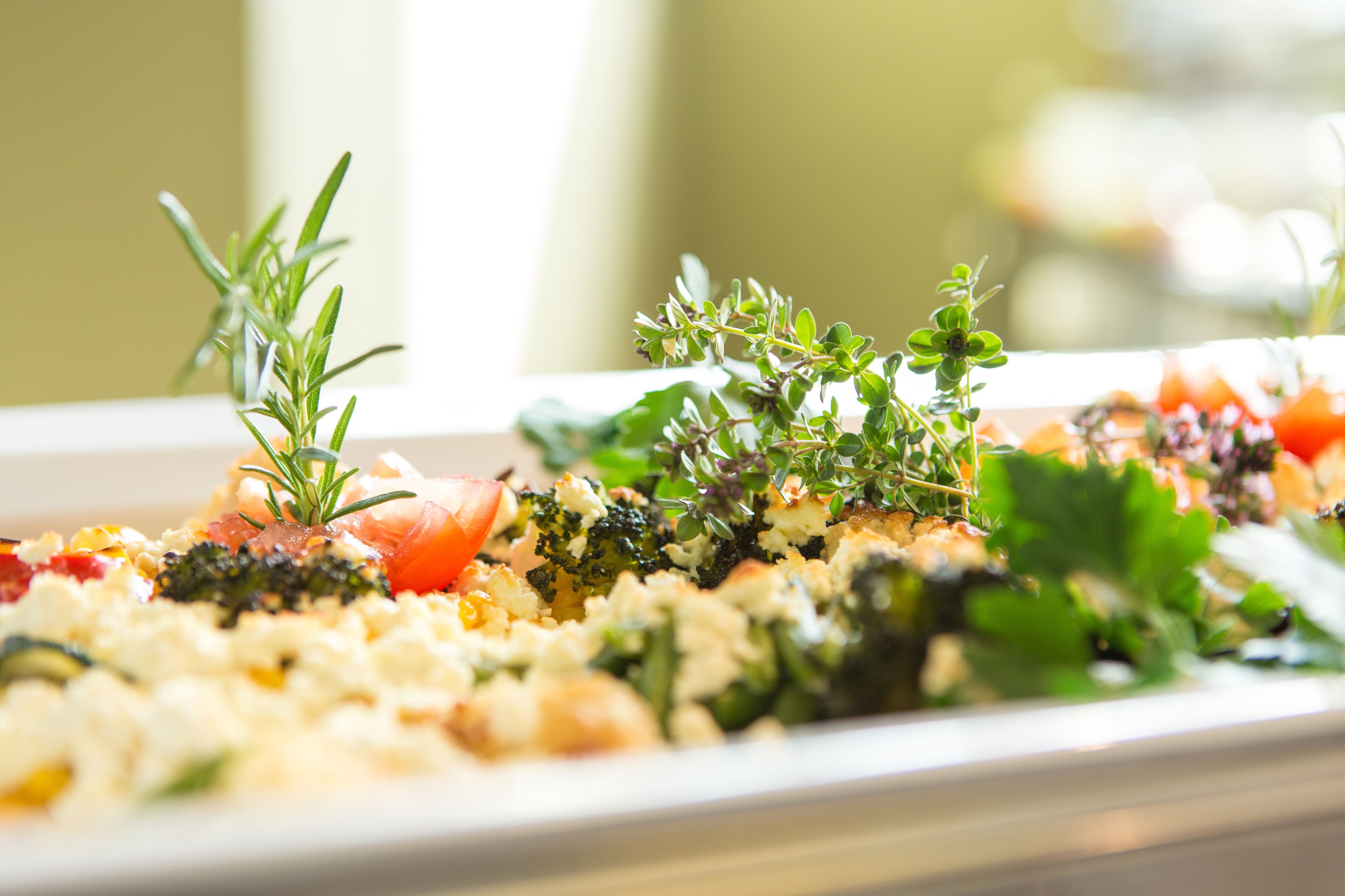 A plate of food with various vegetables and herbs.
