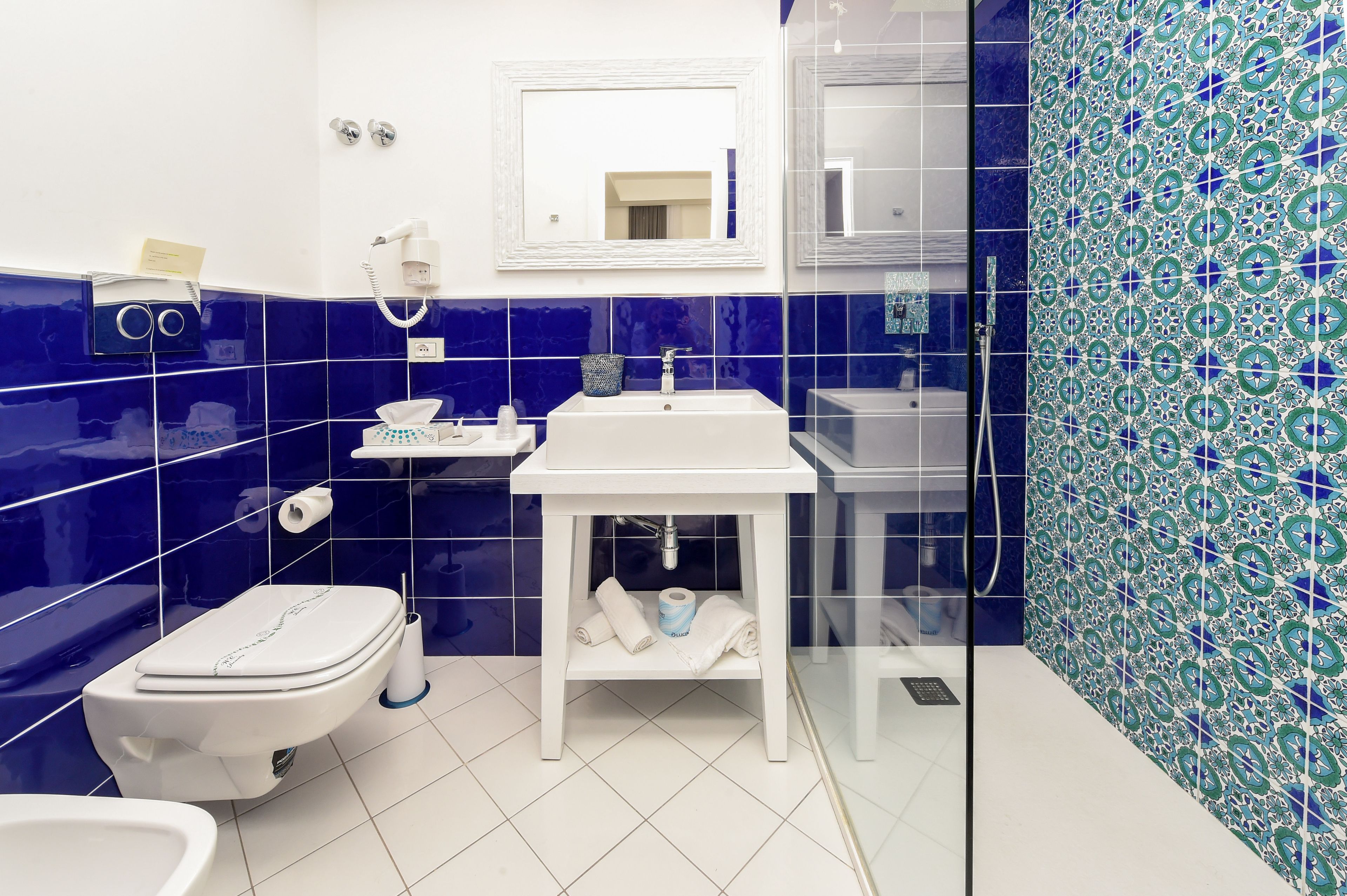 junior suite, city view | bathroom | shower, rainfall showerhead, hair dryer, soap