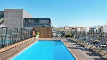 Relax by the pool surrounded by comfortable lounge chairs and a lifebuoy for added safety.