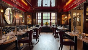 A restaurant with a central seating area, high ceilings, and large windows. - Durrants Hotel (London)