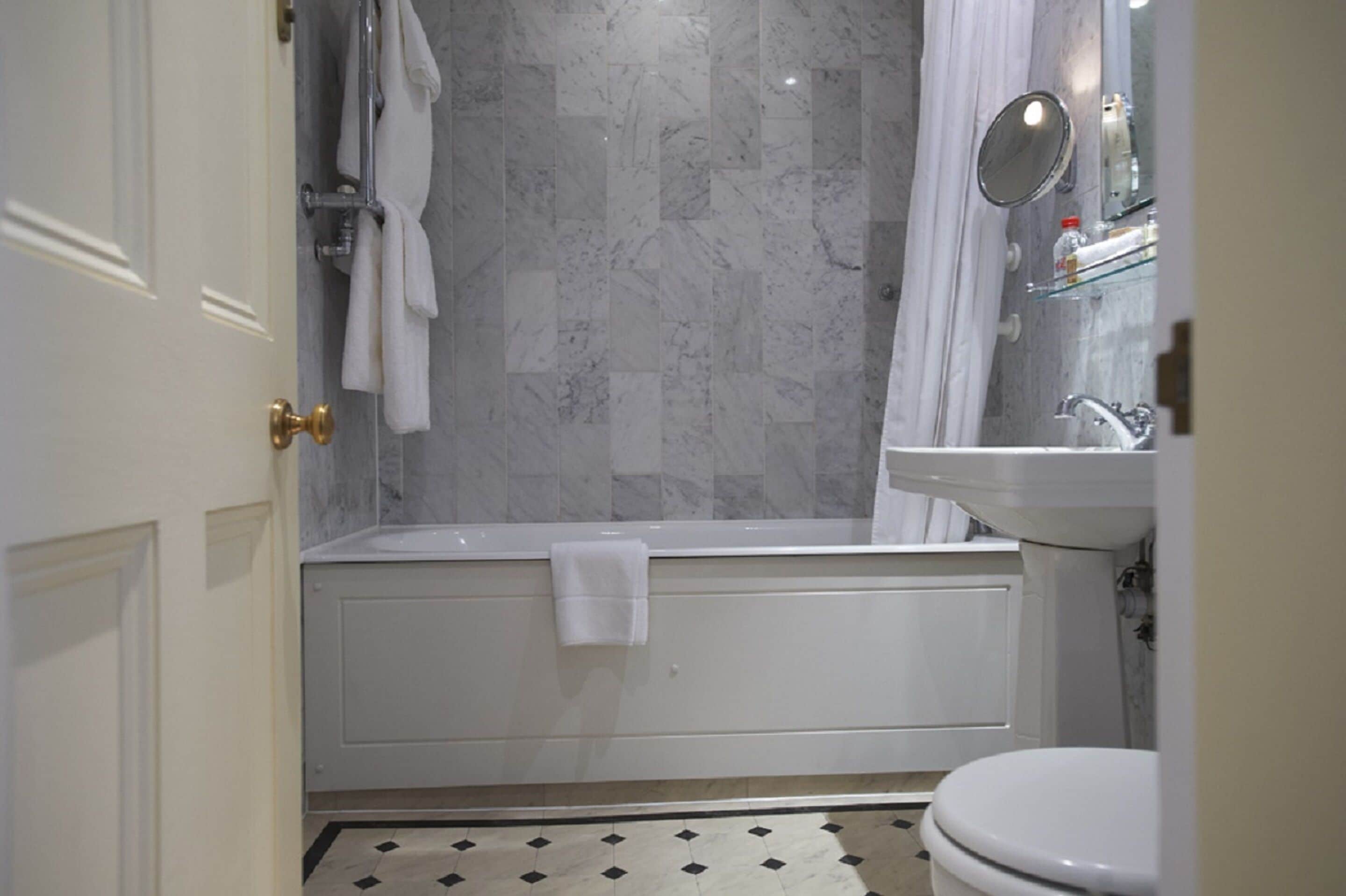 combined shower/bathtub, designer toiletries, hair dryer, towels