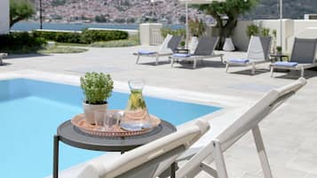 Seasonal outdoor pool, open 9:00 AM to 9:00 PM, pool umbrellas