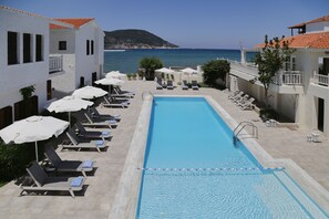 Seasonal outdoor pool, open 9:00 AM to 9:00 PM, pool umbrellas