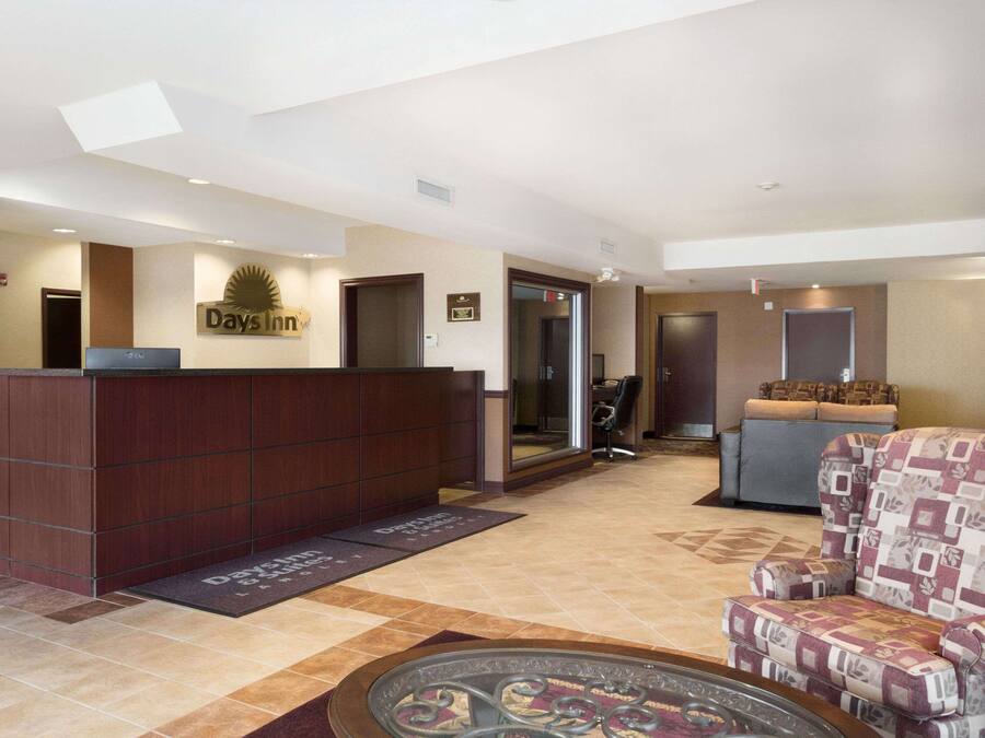 A reception area with a reception desk, a chair, and a couch.