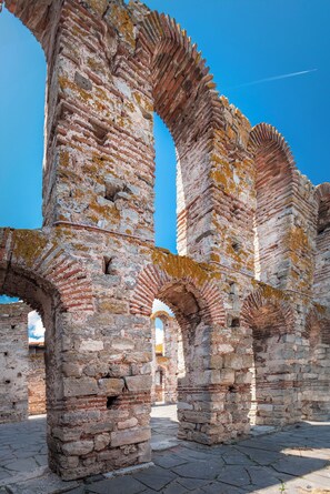Ancient brick ruins with arches and columns, likely part of a historical site.