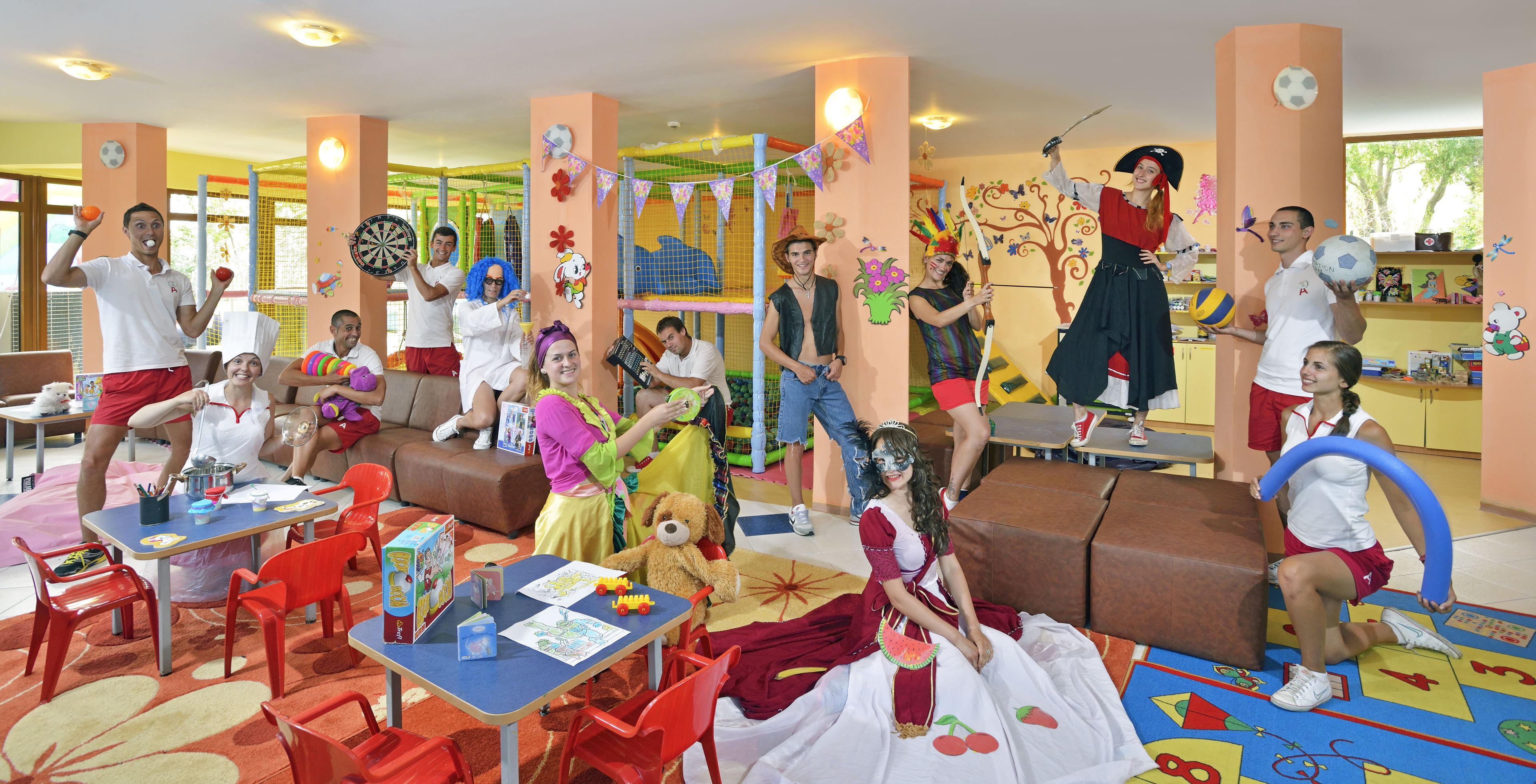 A children's play area with tables, chairs, and colorful play mats.