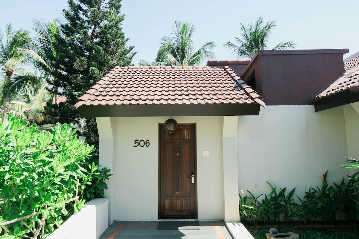 A building with a brown door, number 506, and a tiled roof.