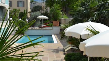 Seasonal outdoor pool, open 7:30 AM to 9:30 PM, pool umbrellas